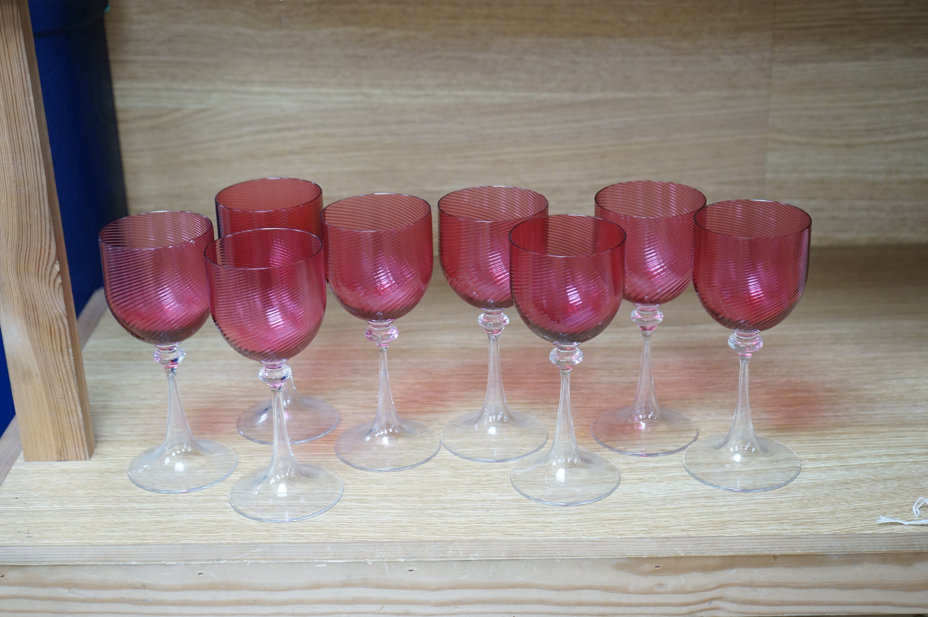 A set of eight cranberry bowl, flute stemmed wine glasses, 16.5cm high